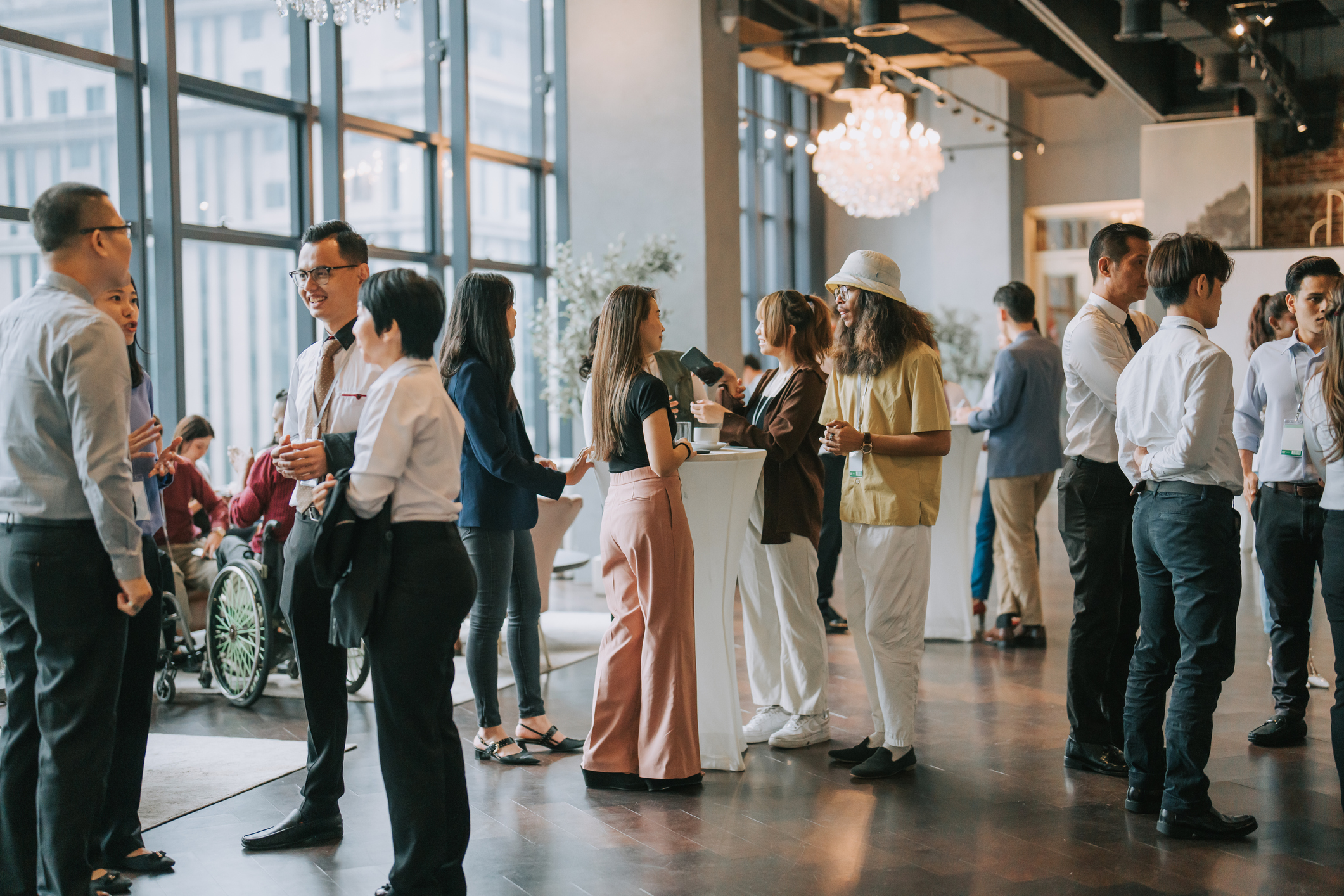 People networking at a professional event in a bright, modern space