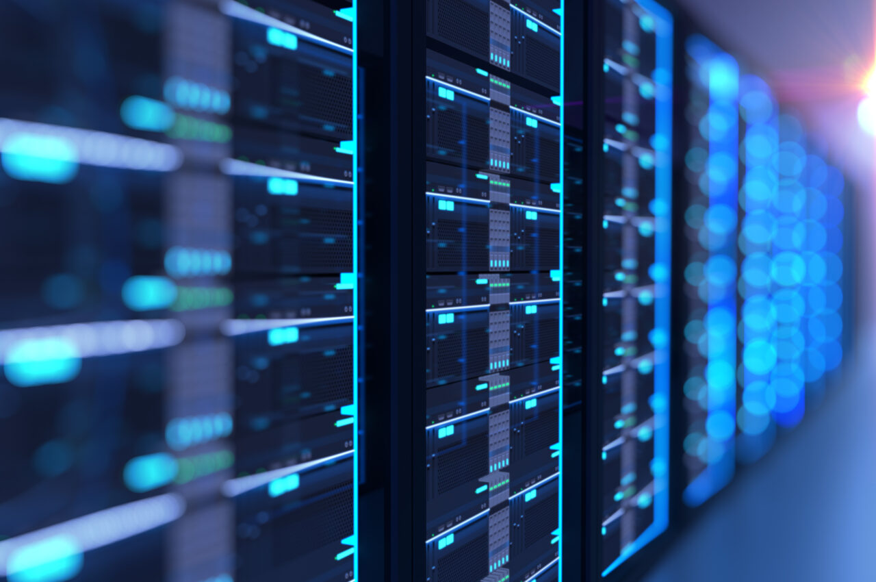 Row of illuminated data servers in a darkened server room